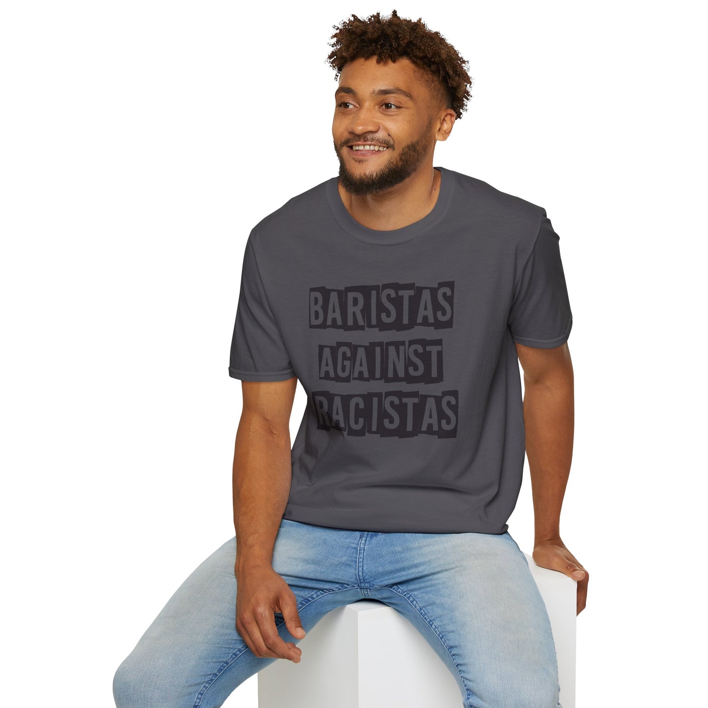 Man sitting while wearing a gray shirt that says Baristas Against Racistas