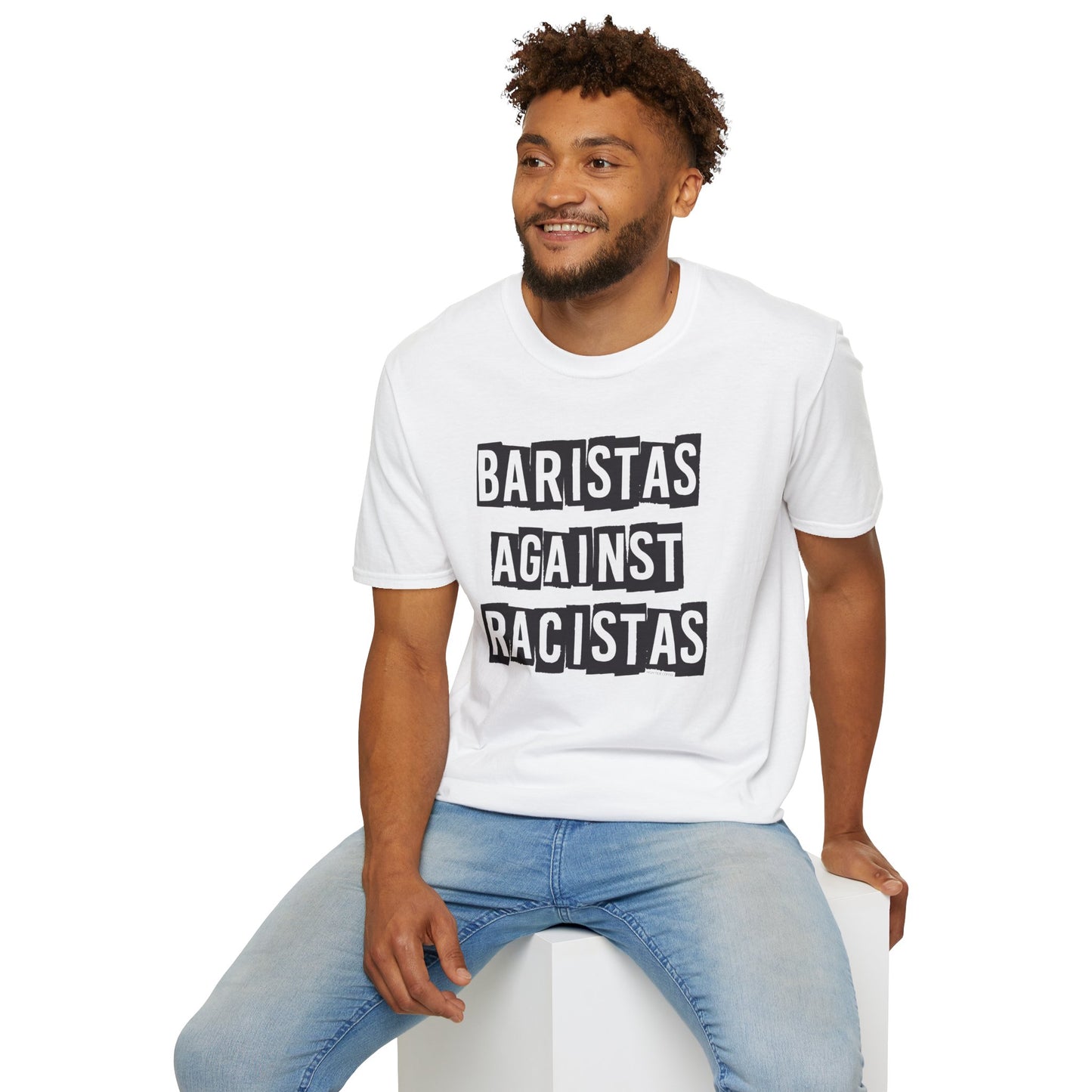 Man sitting while wearing a white shirt that says Baristas Against Racistas