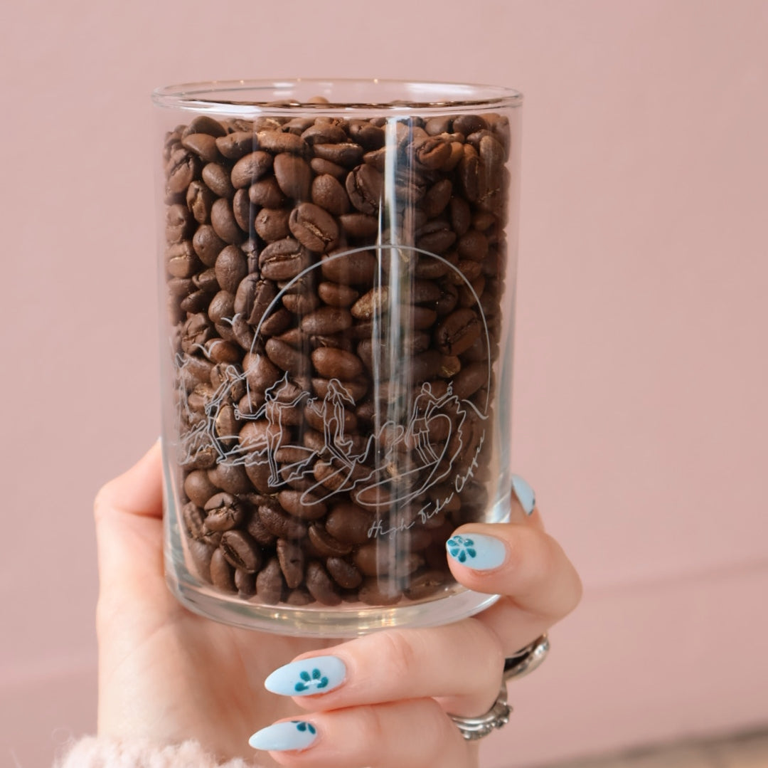 Pint Glass full of coffee beans with surfers printed on it