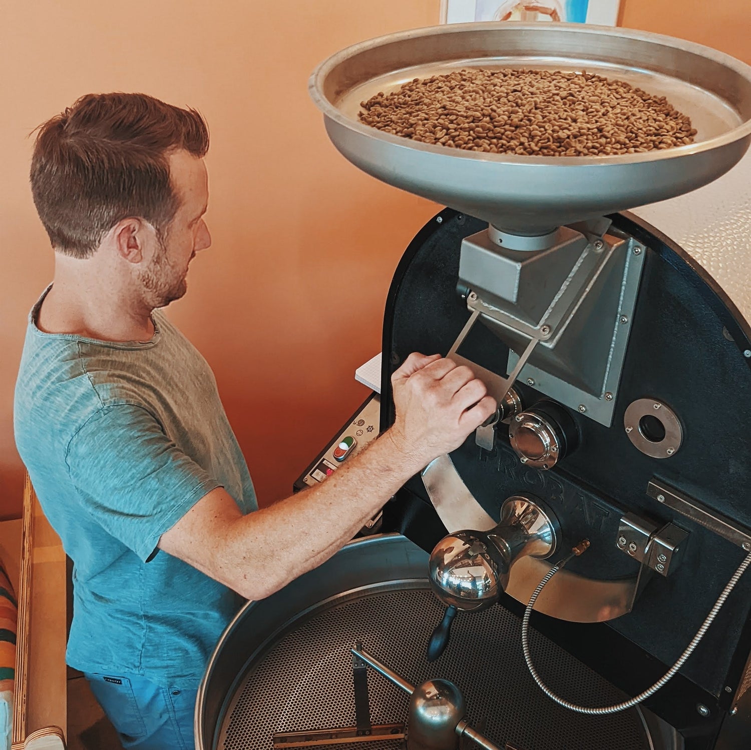 man operating a coffee roasting machine