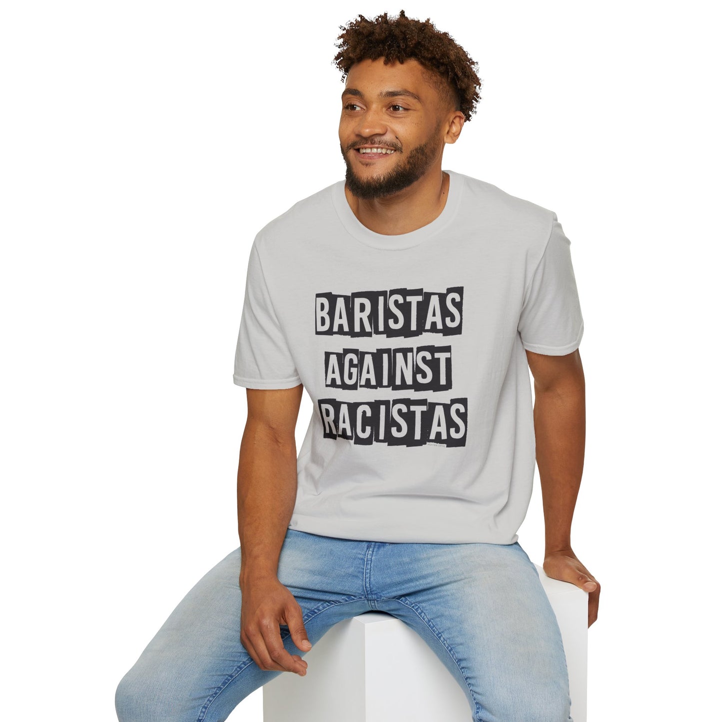 Man sitting while wearing a light gray shirt that says Baristas Against Racistas