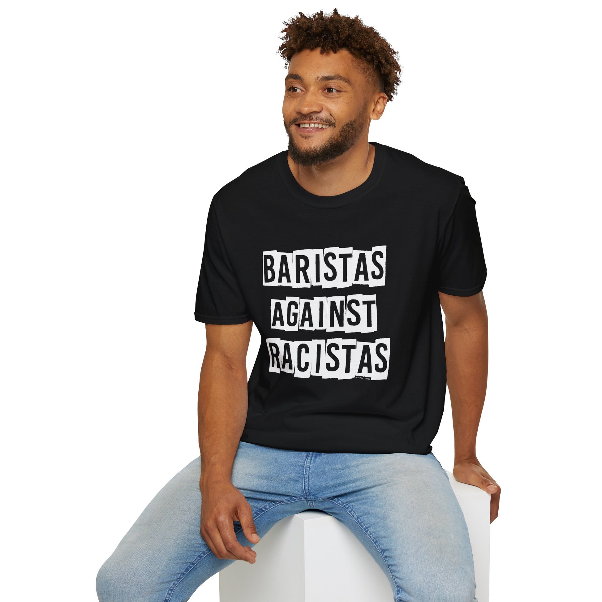 Man sitting while wearing a black shirt that says Baristas Against Racistas