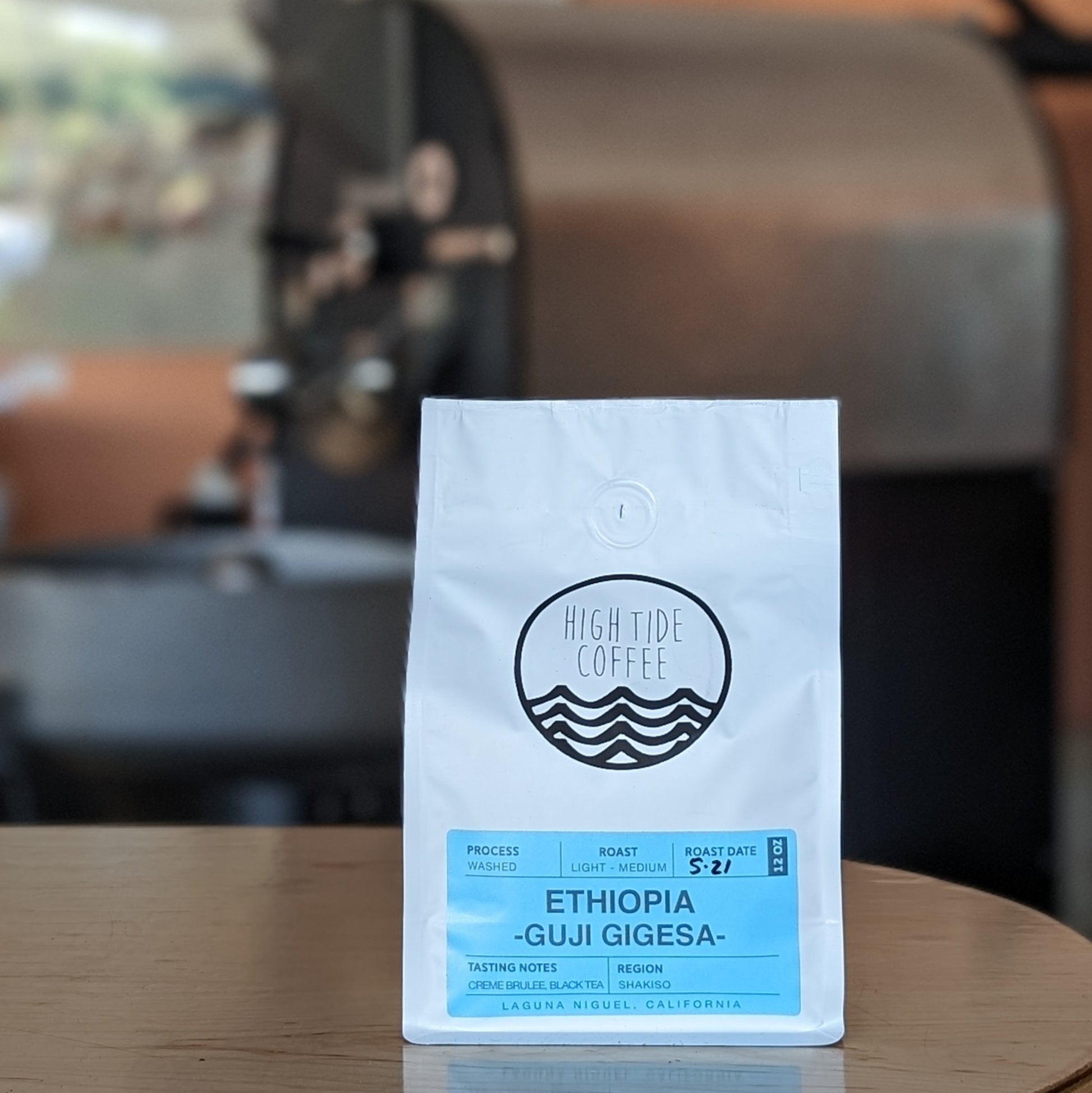 Bag of coffee beans sitting on a wooden table